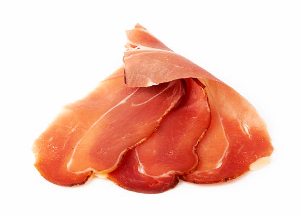 cured bacon Slices of cured bacon on white daequan cook stock pictures, royalty-free photos & images