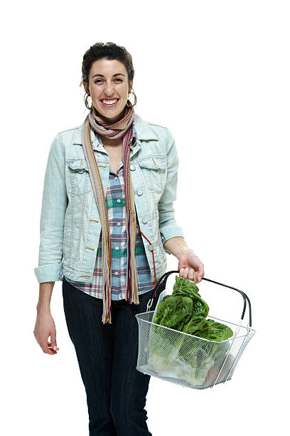 istock Happy young woman standing with basket 486418321