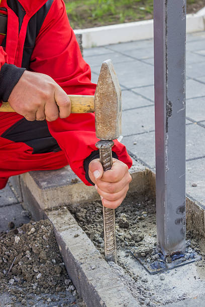 istock hands with hammer and chisels cleaning mortar 486418779