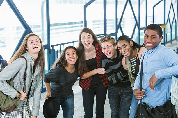 istock Multiracial group of teenagers standing on train platform laughing 486418925