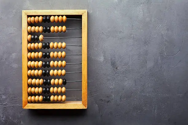 Accounting abacus on gray textured background with copy space