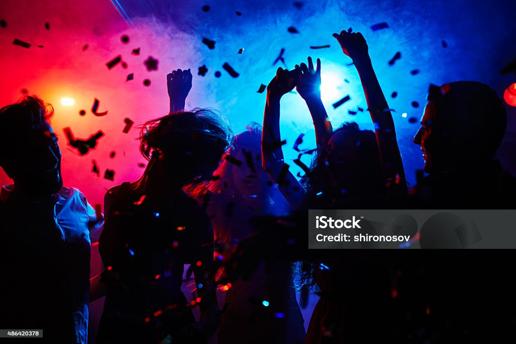 Head is swimming on dance floor Silhouettes of dancers moving in confetti Party - Social Event Stock Photo