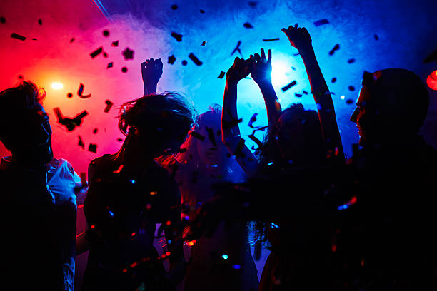Head is swimming on dance floor Silhouettes of dancers moving in confetti dancer stock pictures, royalty-free photos & images