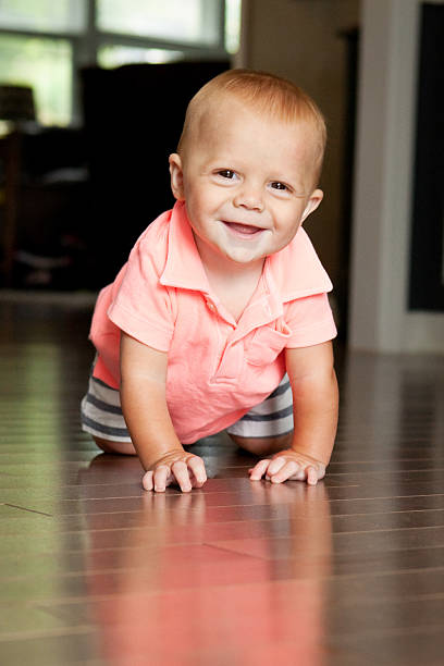 istock Cute Baby Boy Crawling On Floor 486421430