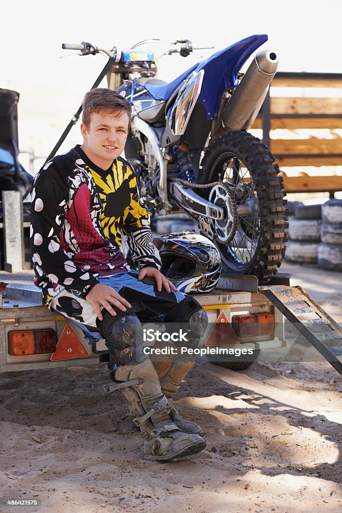 I live for my weekend ride Portrait of a young dirt bike racer sitting on trailer with his bikehttp://195.154.178.81/DATA/i_collage/pi/shoots/783228.jpg Motorcycle Stock Photo