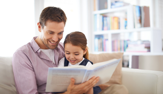 Shot of a young father reading a book with his daughterhttp://195.154.178.81/DATA/i_collage/pi/shoots/783272.jpg