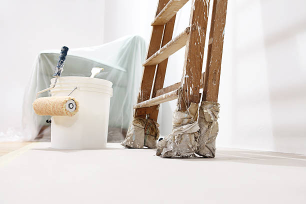 istock painter wall concept, ladder, bucket, roll paint on the floor 486425180