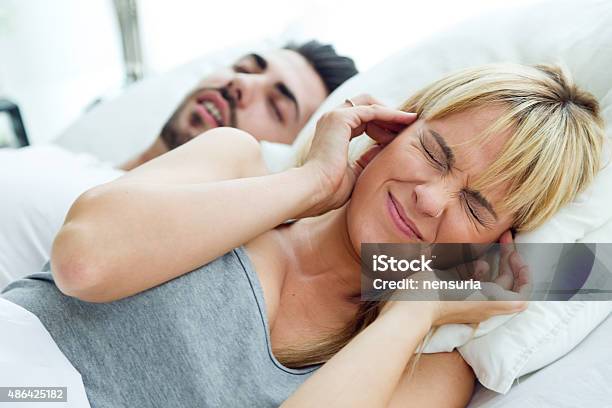 Young Woman Who Can Not Sleep Because Her Husband Snores Stock Photo - Download Image Now
