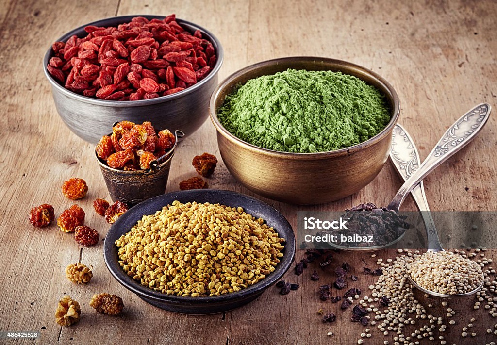 Superfood Bowls and spoons of various superfood on wooden background Antioxidant Stock Photo