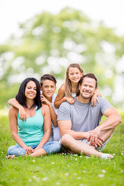 istock Family Sitting and Relaxing in a Park 486425614