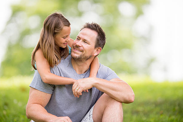 istock Father Daughter Hug in the Park 486425630