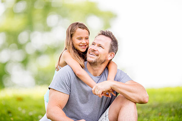 istock Father and Daughter Relaxing in the Park 486425634
