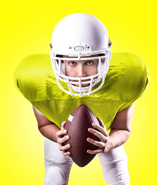 istock Football Player on yellow uniform on yellow background 486425646