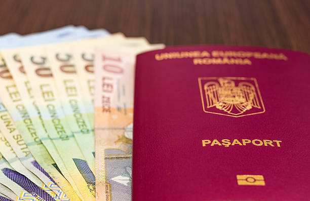 istock Romanian passport with money 486427054