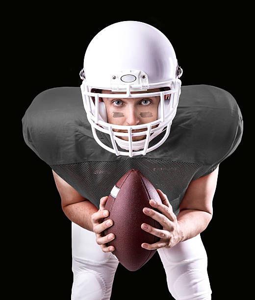 istock Football Player on gray uniform isolated on black background 486427196