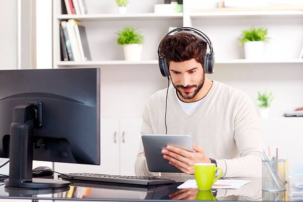 istock Young businessman listening music 486427236