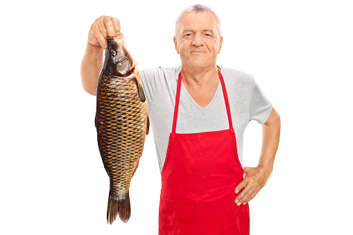 a fisherman holding up a redfish he just caught