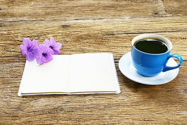 Black coffee in blue cup and Ruellia tuberosa flower