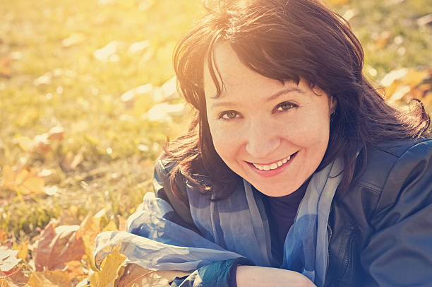 Happy woman enjoying autumn stock photo