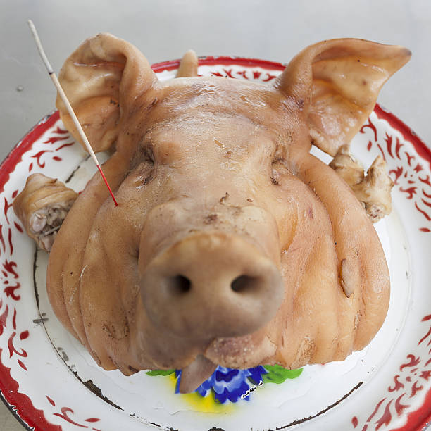 Pig's head chopped off on tray,