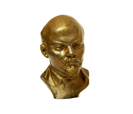 Statuette of Lenin, leader of russian proletarian October revolution in 1917. Isolated bronze bust on white background
