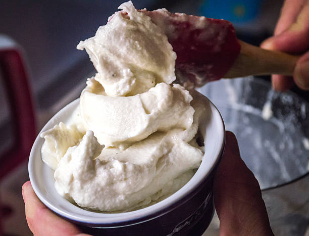 Serving Homemade Ice-cream A male hand serving up freshly made homemade ice-cream into a small ramekin. homemade icecream stock pictures, royalty-free photos & images