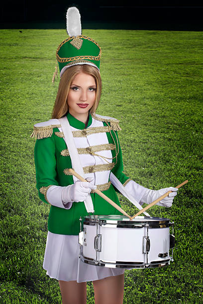 istock drummer with drum on the background of green grass 486439781