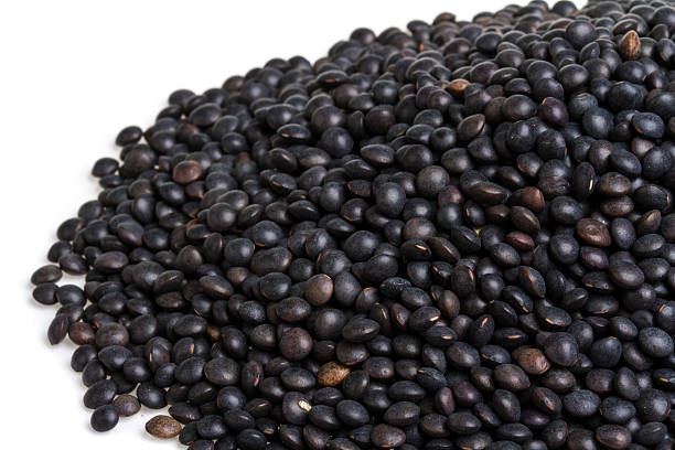 istock Heap of black lentil isolated on white 486439929