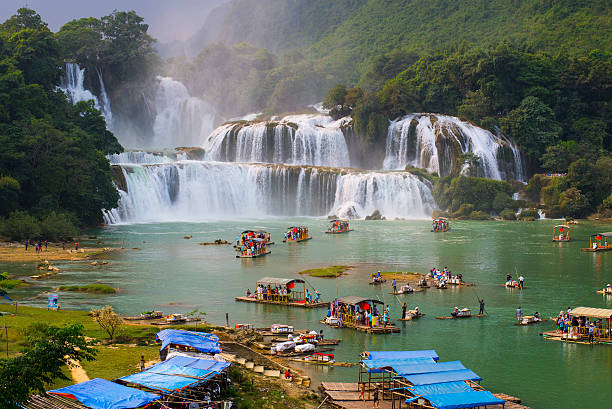 Сaobang, Vietnam - October 4, 2014: Tourist visit Ban Gioc waterfall on boat. Ban Gioc waterfall is along Vietnamese and Chinese board.
