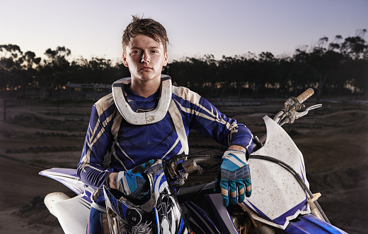 Portrait of a young motocross rider posing on his bikehttp://195.154.178.81/DATA/i_collage/pi/shoots/783228.jpg