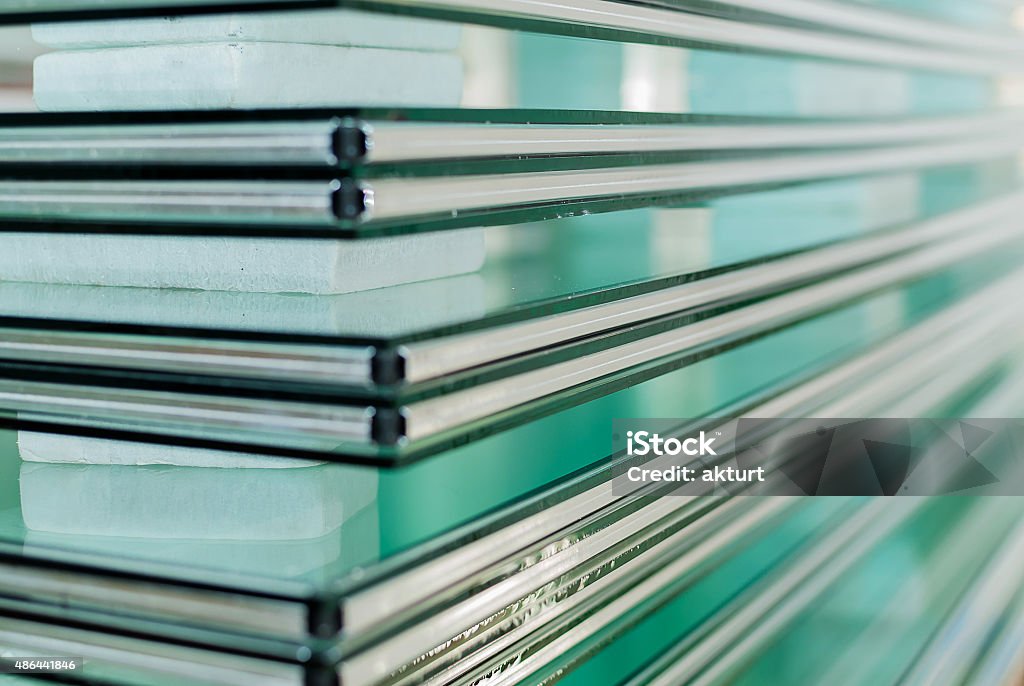 Sheets of Tempered Window Glass Sheets of Factory manufacturing tempered clear float glass panels cut to size Glass - Material Stock Photo