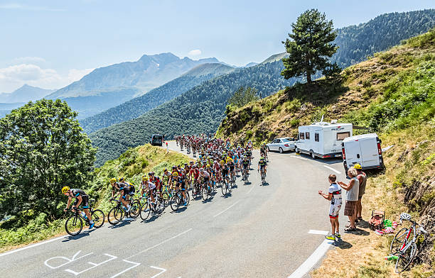 The Peloton on Col d'Aspin - Tour de France 2015 Col D'Aspin,France- July 15,2015: The peloton climbing the road to Col D'Aspin  in Pyrenees Mountains during the stage 11 of Le Tour de France 2015. tour de france stock pictures, royalty-free photos & images