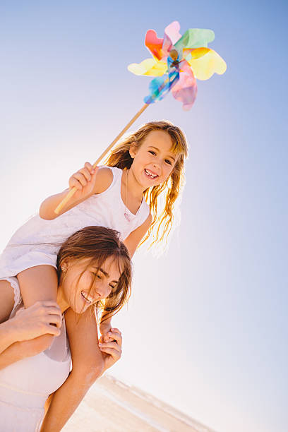 istock Mother carrying daughter on shoulders 486443043