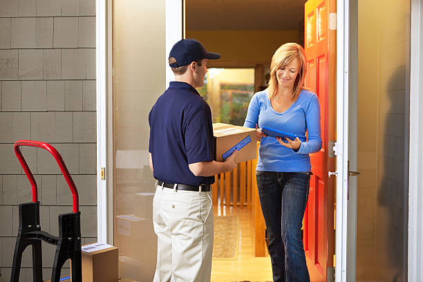 istock Delivery Person Delivering Package Box Container to Home Customer 486443488