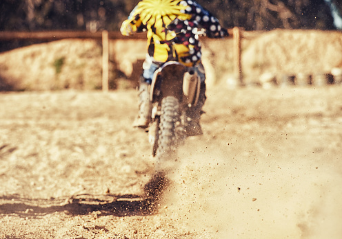 Cropped shot of motocross rider with a trail of dust behind himhttp://195.154.178.81/DATA/i_collage/pi/shoots/783228.jpg