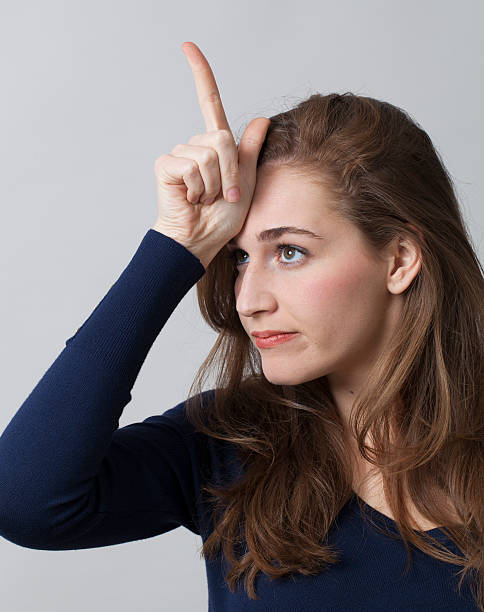 istock frustrated 20's woman accusing herself with L sign on forehead 486446838