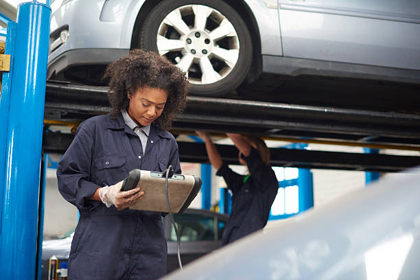 istock female garage mechanic conducting diagnostic check. 486450008