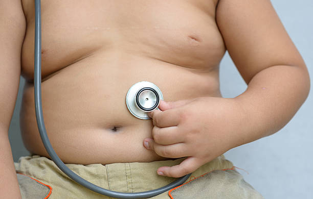 istock Hand boy check big stomach by stethoscope 486454340