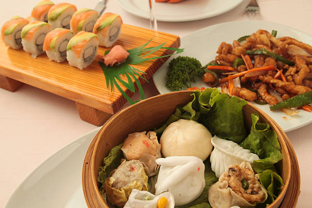 istock wontons wrappers in wooden bowl and sushi rolls with ginger 486454664