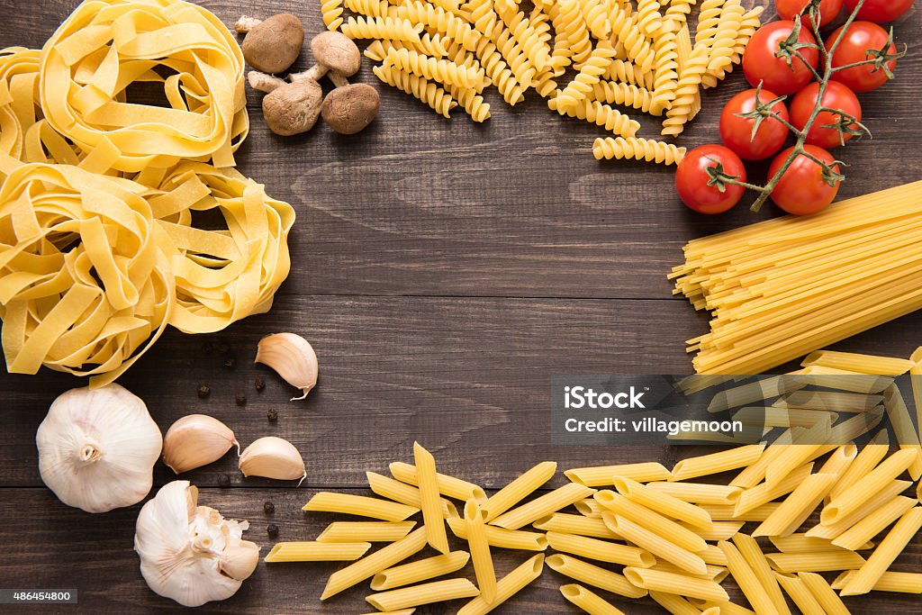 Mixed dried pasta selection on wooden background Mixed dried pasta selection on wooden background. 2015 Stock Photo
