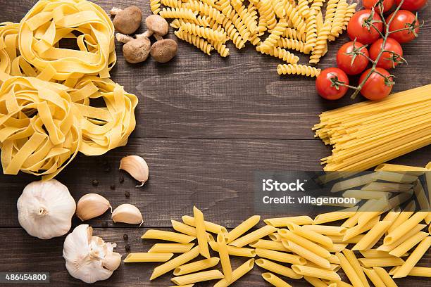 Mixed Dried Pasta Selection On Wooden Background Stock Photo - Download Image Now - 2015, Border - Frame, Cereal Plant