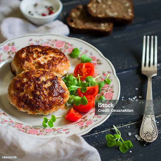 Pork Cutlet And Vegetable Salad On A Dark Wooden Background Stock Photo - Download Image Now