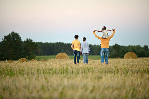 istock Happy family in wheat field 486455328