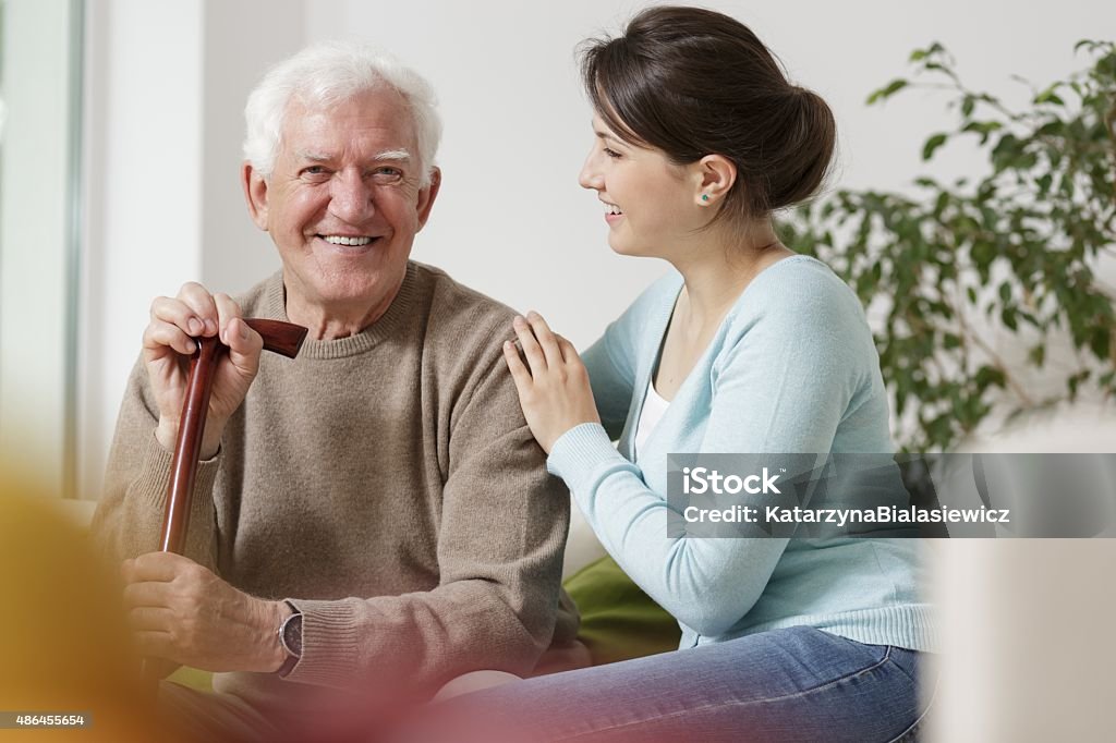 Granddaughter caring about her grandfather Beauty granddaughter caring about her disabled grandfather Grandfather Stock Photo