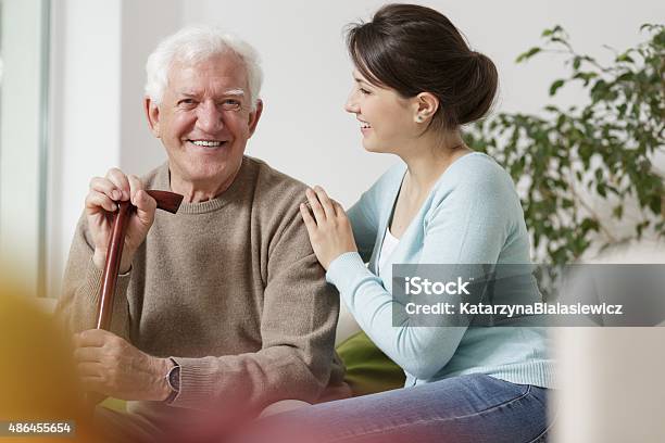 Granddaughter Caring About Her Grandfather Stock Photo - Download Image Now - Grandfather, Home Caregiver, Assistant
