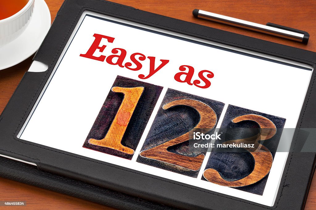 easy as 1, 2, 3 concept easy as 1, 2, 3 concept - text and numbers in letterpress wood type on a digital tablet Effortless Stock Photo