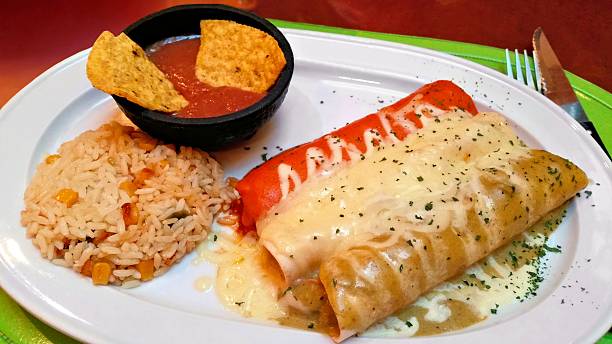istock Red white and green enchiladas with rice and beans 486455898