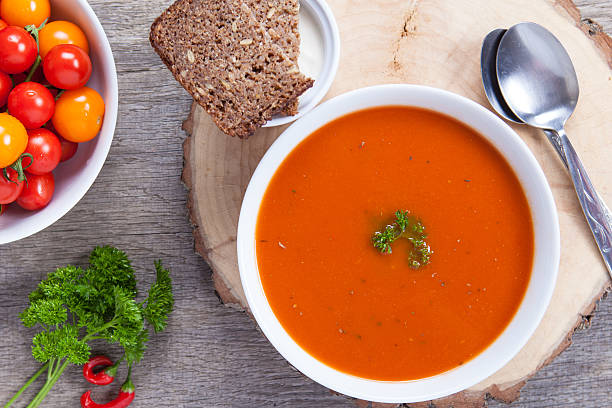 istock Tomato soup with fresh herbs, chili, tomatoes 486455942