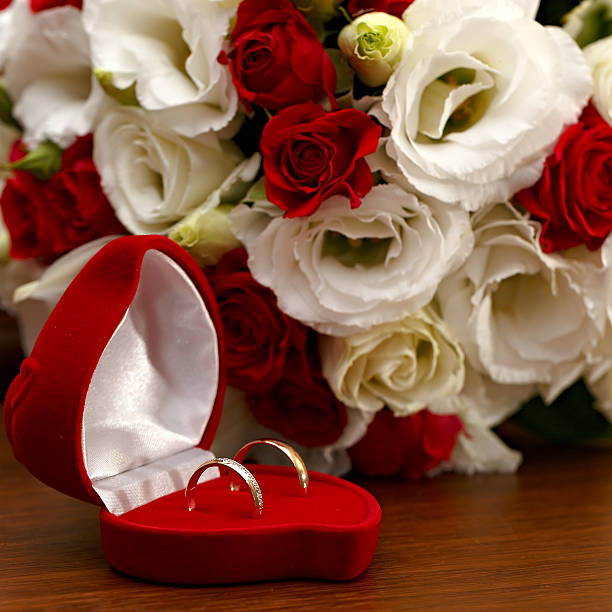 istock Wedding rings, gift box and flowers for the bride. 486455960