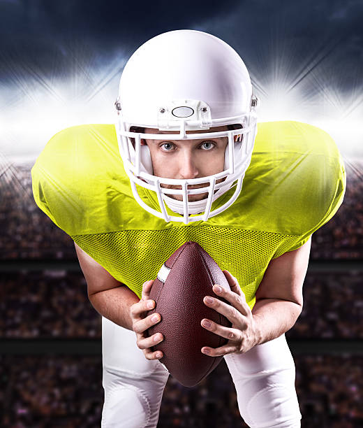 istock Football Player on yellow uniform in the stadium 486456076